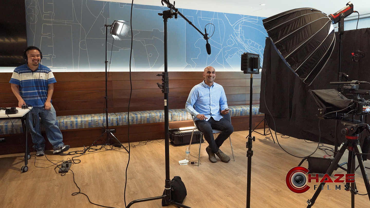 Behind-the-scenes on video production set with talent on screen filming talking head educational videos