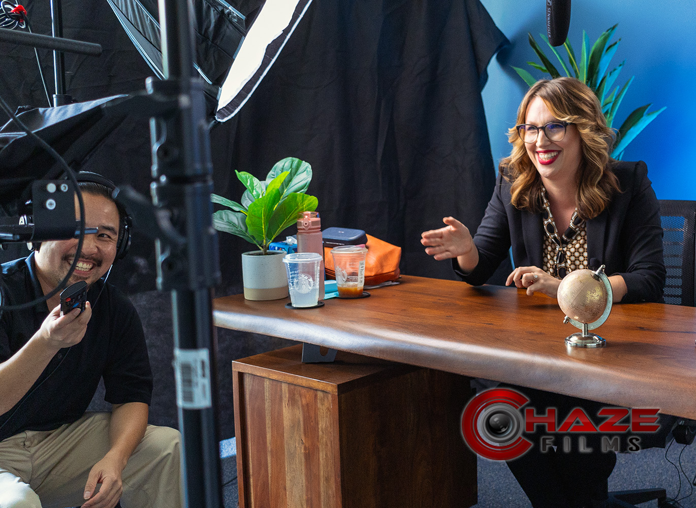 Behind-the-scenes with Boston videographer working with immigration lawyer on their talking head educational videos laughing between takes